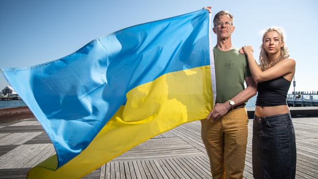 09-02-2023 Jon Metrikas with daughter Lulu and the Ukraine flag. Jon's son Felix is involved in training military personnel in Ukraine. Picture: Brad Fleet