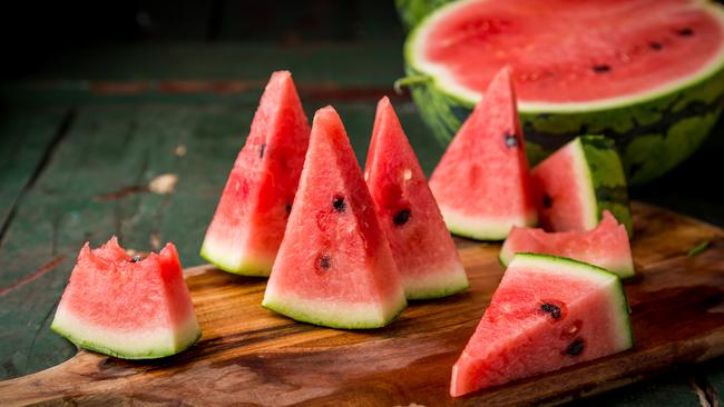 Watermelon sliced on wood background