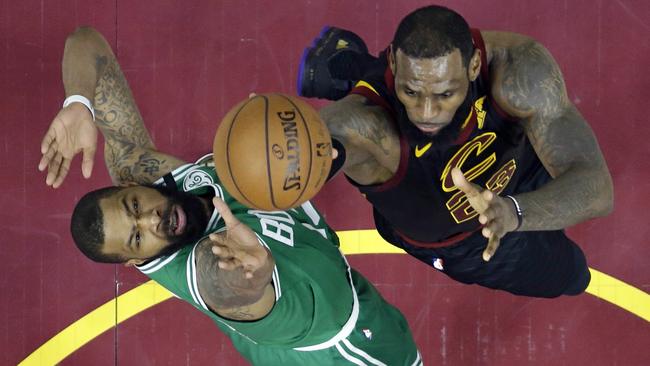 Cleveland Cavaliers' LeBron James, right, drives to the basket against Boston Celtics' Marcus Morris in game 4. Picture: AP.