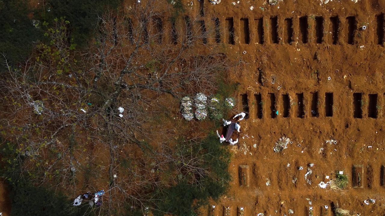 Aerial view of a coffin being buried at Vila Formosa cemetery, Sao Paulo, Brazil. Picture: Miguel Schincariol/AFP