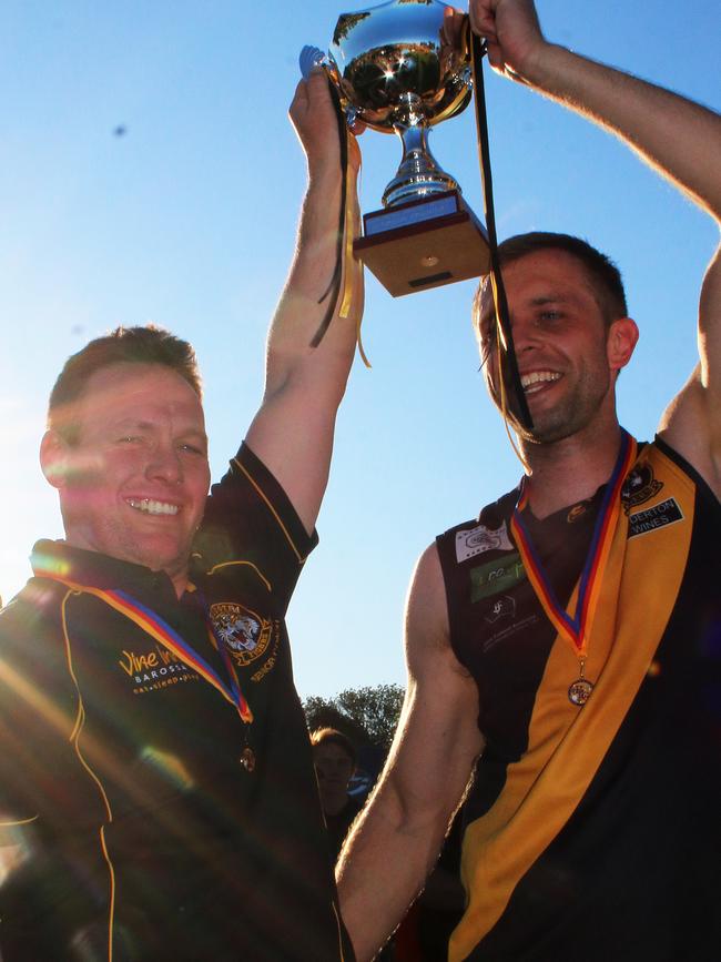 Darren Reeves (left) and Nuriootpa captain Craig Gogoll hoist the cup aloft after the Tigers won the 2015 Barossa, Light and Gawler Football Association grand final. Picture: Peter Argent
