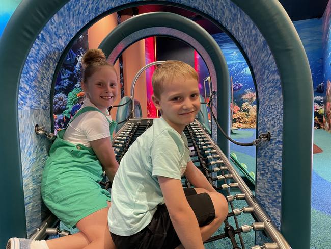 Kayla, 10, and Rory Downes, 6, try out the interactive activity based equipment in Reef Play, the new play space in Willows Shopping Centre. Picture: Leighton Smith.