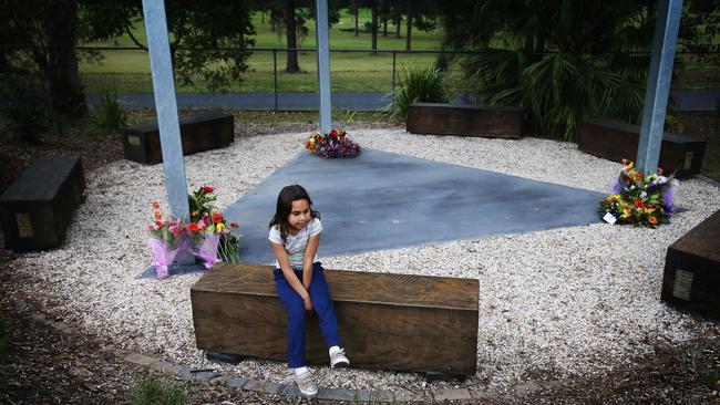 11/8/16: The NSW Commissioner of Police, Andrew Scipione attends a  ceremony in Bowraville, NSW with the families of the 3 children murdered in Bowraville whose deaths have gone unsolved for almost 26 years. A young local aboriginal girl plays in the memorial for the 3 murdered children after everybody had left. John Feder/The Australian.