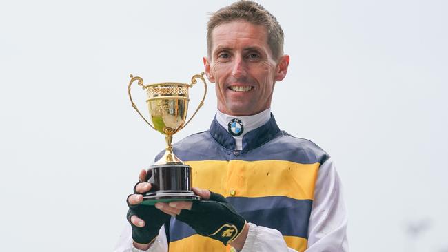 Nash Rawiller holds the winning trophy. Picture: Scott Barbour