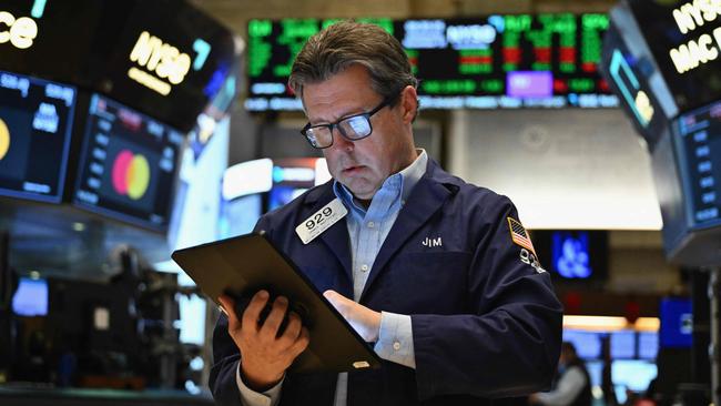 Traders work on the floor of the New York Stock Exchange (NYSE) at the opening bell on November 13, 2024, in New York City. (Photo by ANGELA WEISS / AFP)