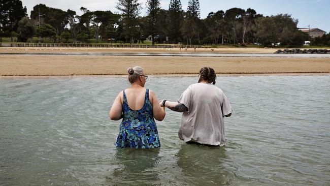 Friend Kelly Russ wades out into the water with Kay (right). Picture: Sam Ruttyn