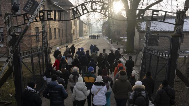 Visitors walk through the ''Arbeit Macht Frei" (Work Sets You Free) gate at the Memorial and Museum Auschwitz-Birkenau, a former Nazi German concentration and extermination camp, in Oswiecim, Poland. Picture: AP Photo