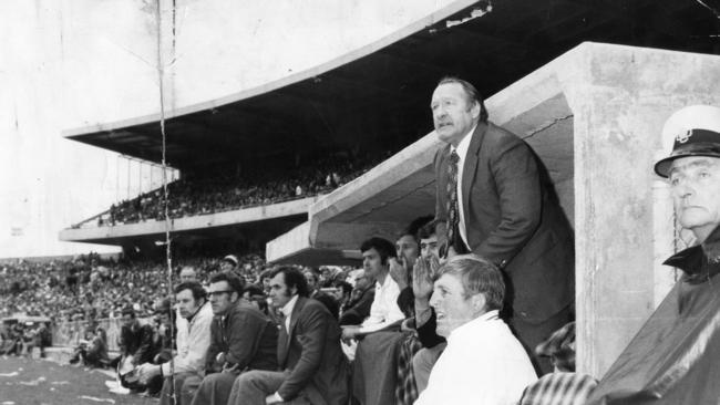 Jack Oatey jumping out of the coach’s box during the 1974 SANFL grand final between Sturt and Glenelg.