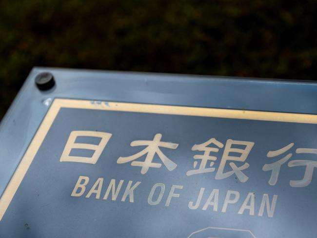 (FILES) A guide sign reading "Bank of Japan" is seen at the BoJ headquarters building in Tokyo on July 31, 2024. The Bank of Japan's deputy governor Shinichi Uchida said on August 7, 2024 that officials would stick to their ultra-loose monetary policies given recent market volatility, leading to a big drop in the yen. (Photo by Kazuhiro NOGI / AFP)