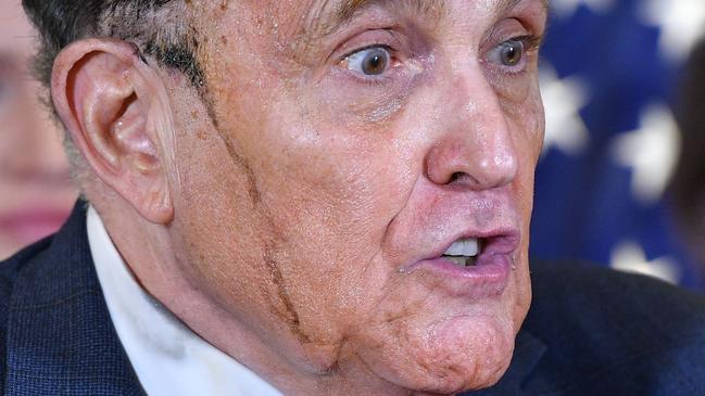 The dye runs as Rudy Giuliani perspires as at the Republican National Committee headquarters in Washington on Friay. Picture: AFP