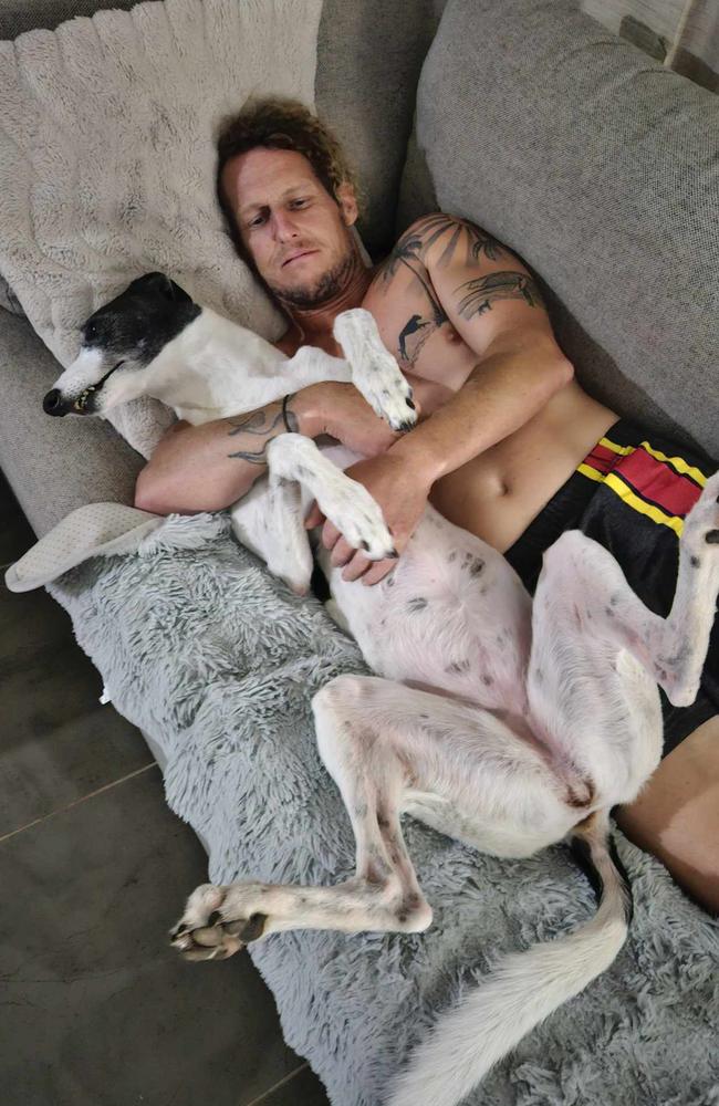 Simon Hayes cuddling the family dog. Photo: contributed