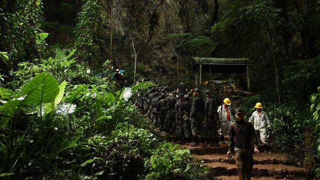 Thai soldiers at the mouth of the Tham Luang cave on June 26 when the 12 boys and their coach were still trapped inside. Picture: AFP 