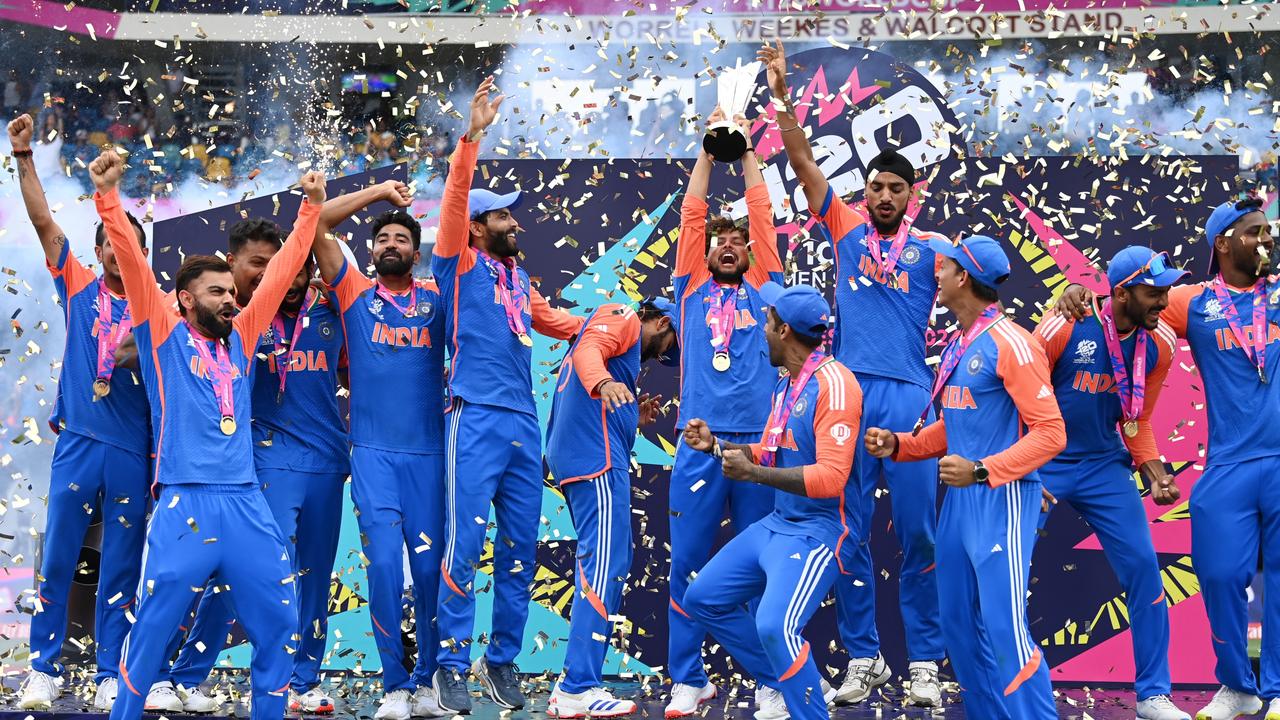 India's Kuldeep Yadav lifts the ICC Men's T20 Cricket World Cup Trophy. Photo by Gareth Copley/Getty Images