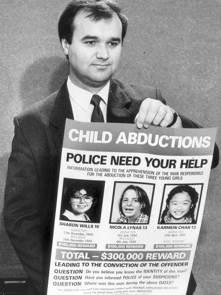 David Sprague, head of Operation Spectrum, holding poster of supposed Mr Cruel victims.