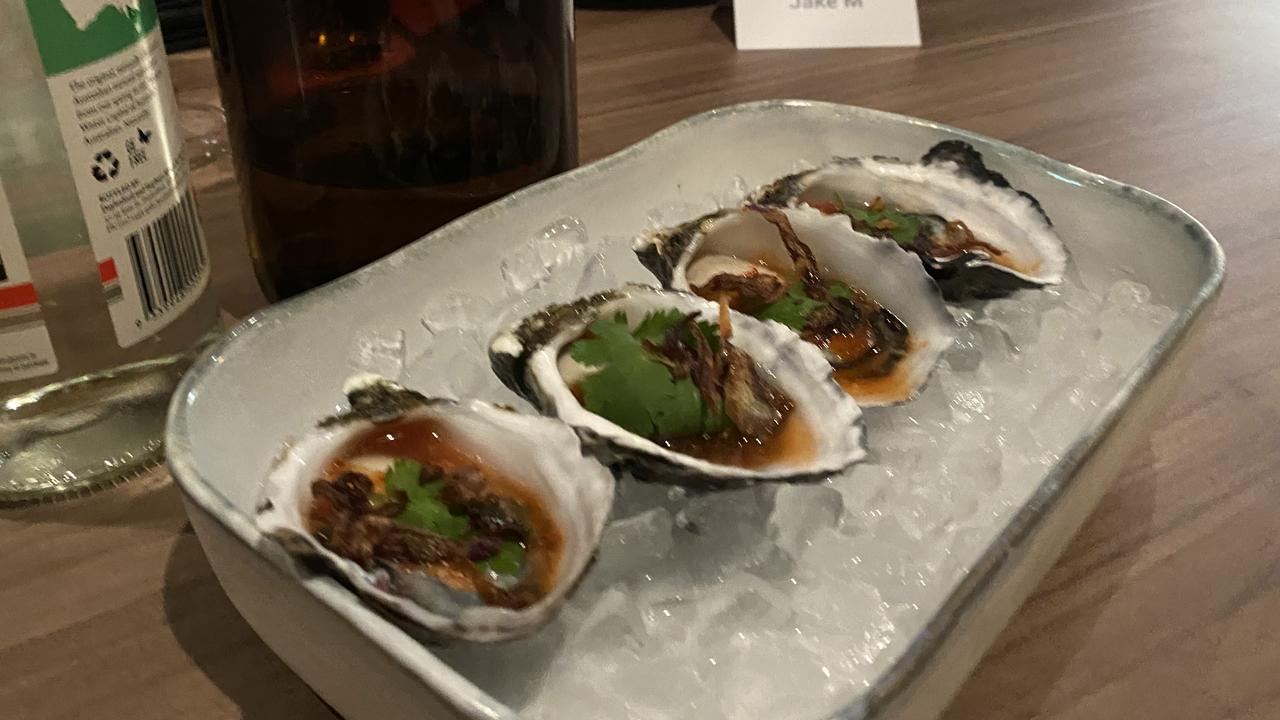 Coffin Bay oysters with red nahm jim, coriander and fried shallots. Picture: Grace McKinnon