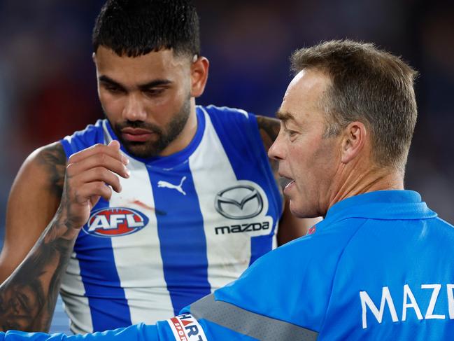 MELBOURNE, AUSTRALIA - AUGUST 12: Alastair Clarkson, Senior Coach of the Kangaroos speaks with Tarryn Thomas during the 2023 AFL Round 22 match between the North Melbourne Kangaroos and the Essendon Bombers at Marvel Stadium on August 12, 2023 in Melbourne, Australia. (Photo by Michael Willson/AFL Photos via Getty Images)