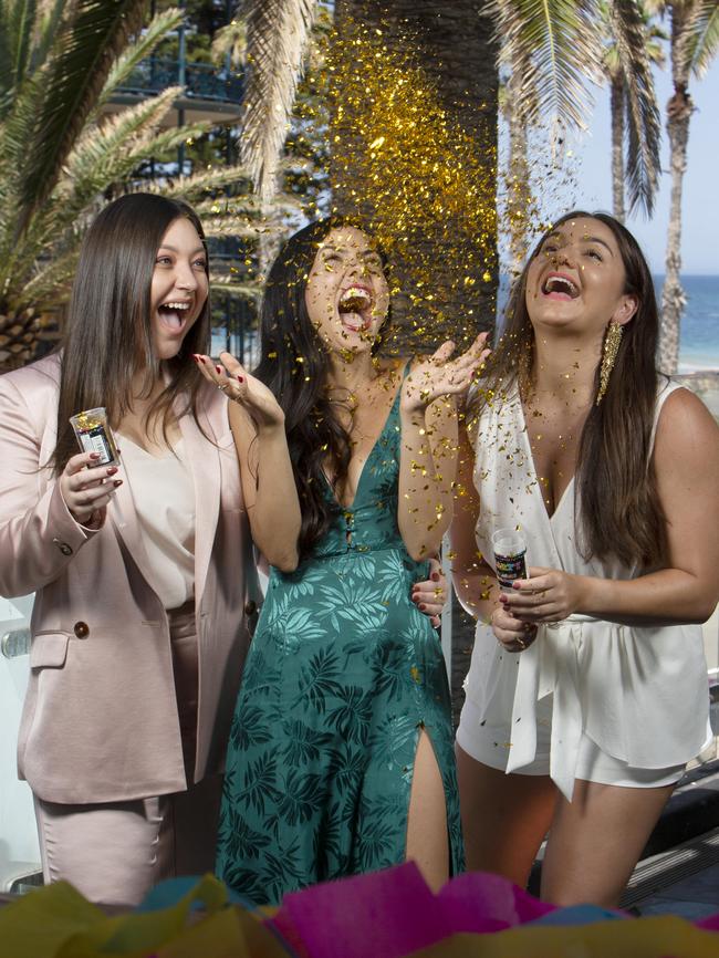 Friends Kassie Ladas, Cassandra Momone and Mia Louca prepare to celebrate the arrival of 2020 at the Moseley Bar and Kitchen in Glenelg. Picture: AAP / Emma Brasier