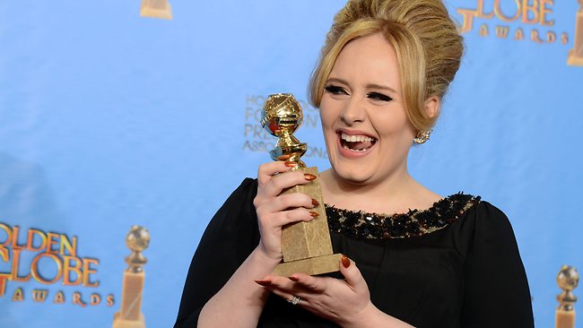 Adele poses with the award for best original song. Picture: AP