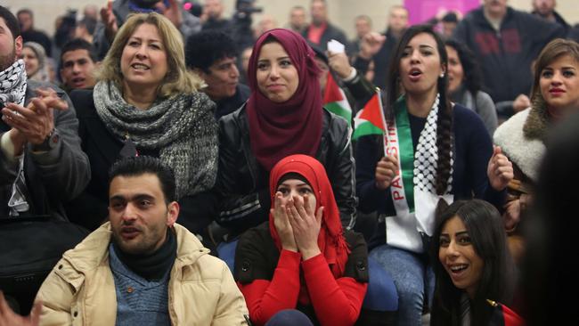 Ahrar Jabarin (bottom C) wife of Palestinian footballer Hisham Salhi watches the Japan game.