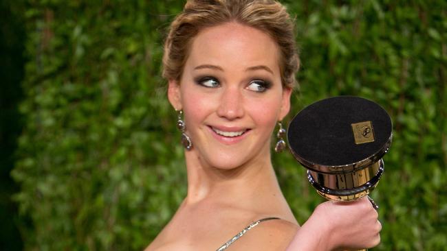 Jennifer Lawrence carrying her Oscar for best actor at 2013 Vanity Fair Oscar Party. Picture: AFP