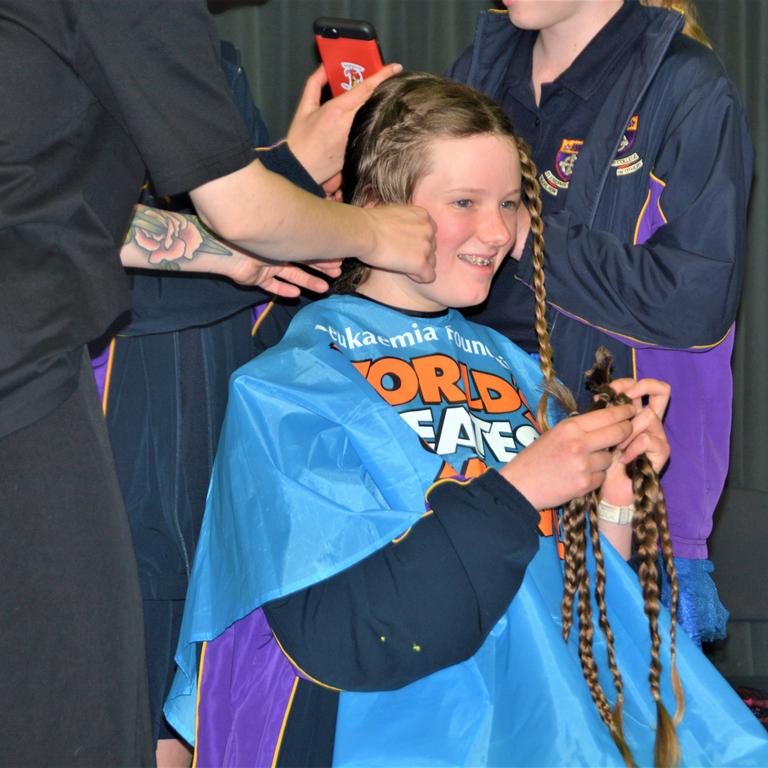 At the St Joseph's College 2023 World's Greatest Shave event is Meghan Ellis getting her cut by hairdresser Caitlin Symes from the Hair Room on Russell. Picture: Rhylea Millar