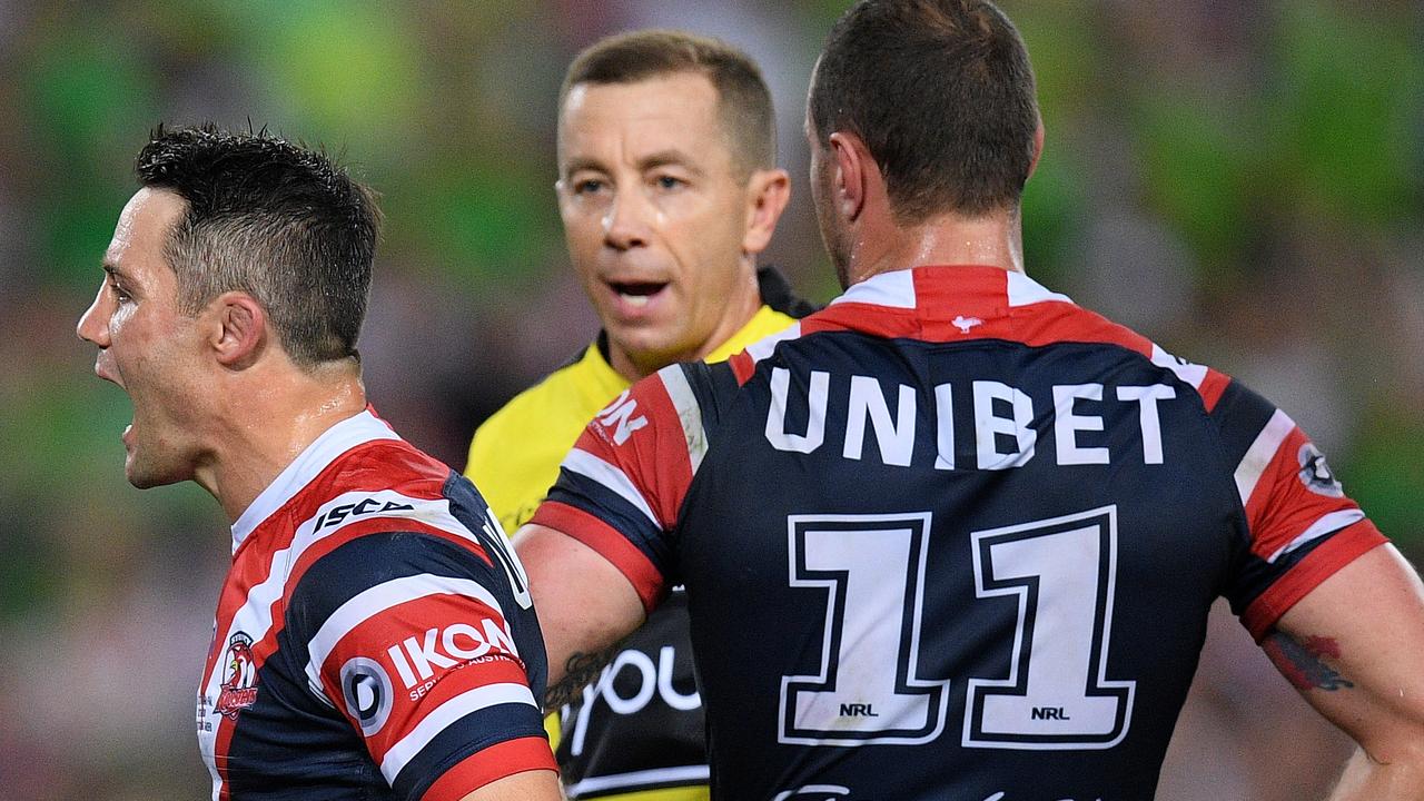 Cooper Cronk of the Roosters (left) reacts as he is sent to the sin bin by referee ben Cummins during the 2019 NRL Grand Final.