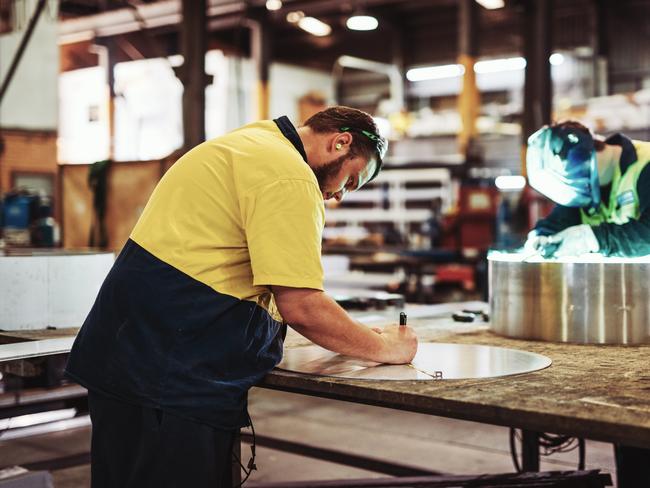 Manual workers and qualified workforce working in metal processing and electric industry Australian manufacturing workers generic, blue collar