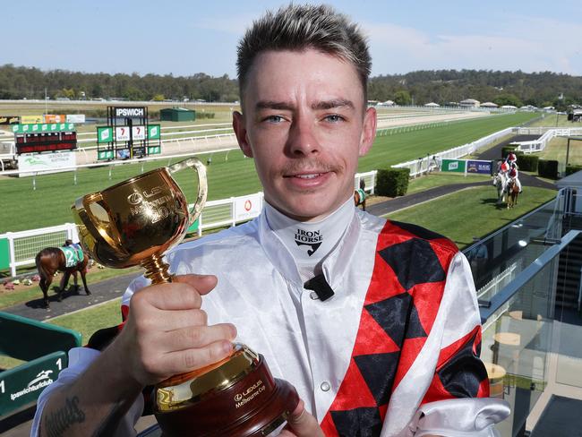 Melbourne Cup winning jockey Robbie Dolan with the Cup trophy at the Ipswich Turf Club, Bundamba. Picture: Liam Kidston