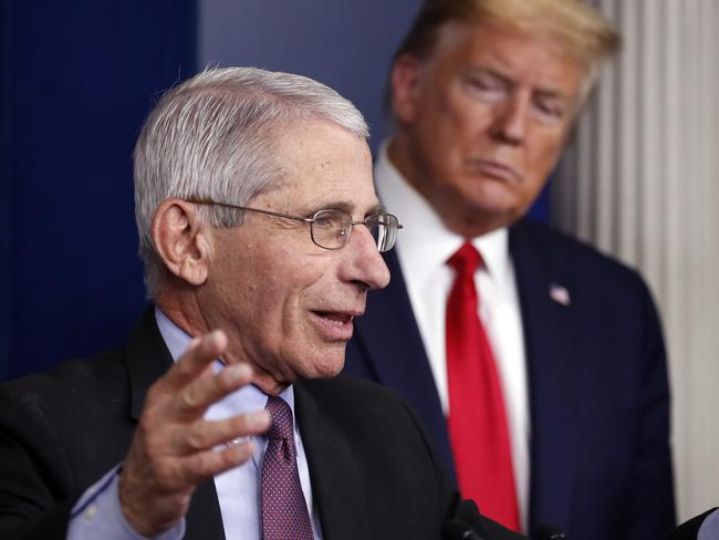 Mr Trump looks on as Dr Fauci makes a point to the press. Picture: AP