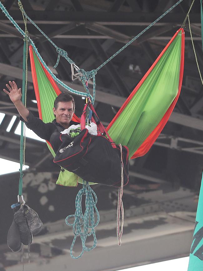 The protester then suspended himself from the Brisbane landmark. Picture: Peter Wallis