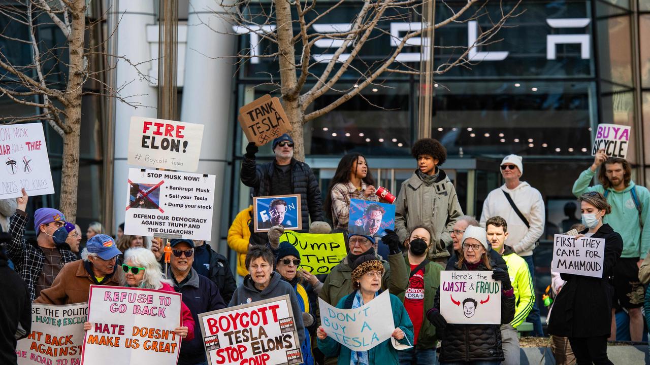 Protesters hold signs and sing chants during a protest against Elon Musk in Boston. Picture: Joseph Prezioso/AFP