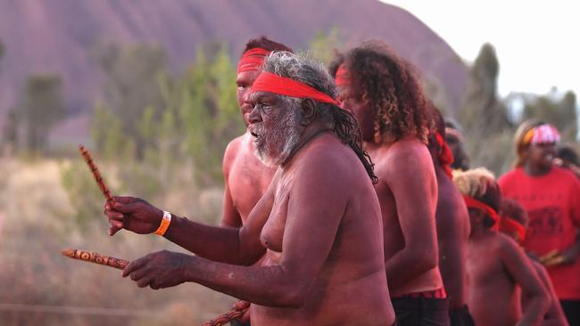 Indigenous Anangu perform a traditional dance during the ceremony marking the permanent ban on climbing Uluru. Picture: AFP.