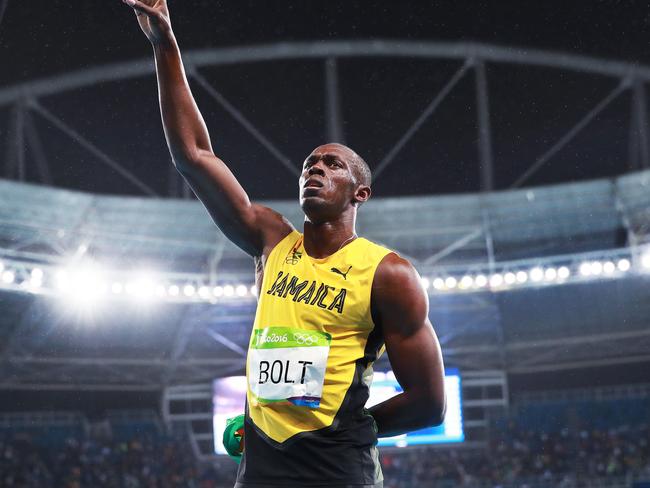 Bolt salutes the crowd.