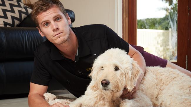 Aaron O'Toole with Stan, 9, who was euthanised two days later after falling ill with megaesophagus. Picture: AAP Image/Matt Loxton