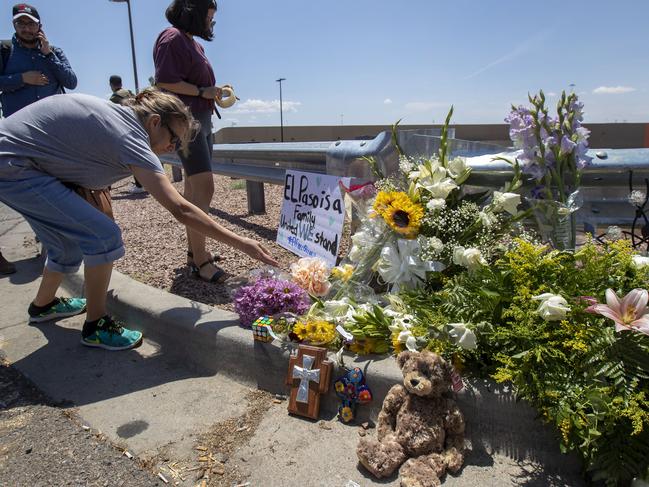 El Paso residents place flowers at a makeshift memorial for the victims of the mass shooting at a shopping complex in El Paso, Texas. Picture: AP