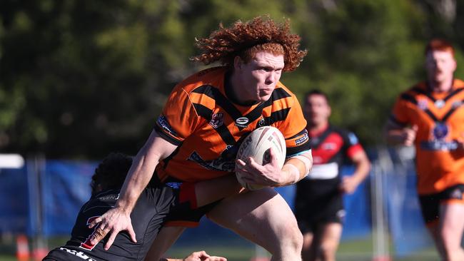 Brock Hamill of the Southport Tigers runs at the Mudgeeraba Redbacks defence during their RLGC A Grade clash at Firth Park, Mudgeeraba. Photograph : Jason O'Brien