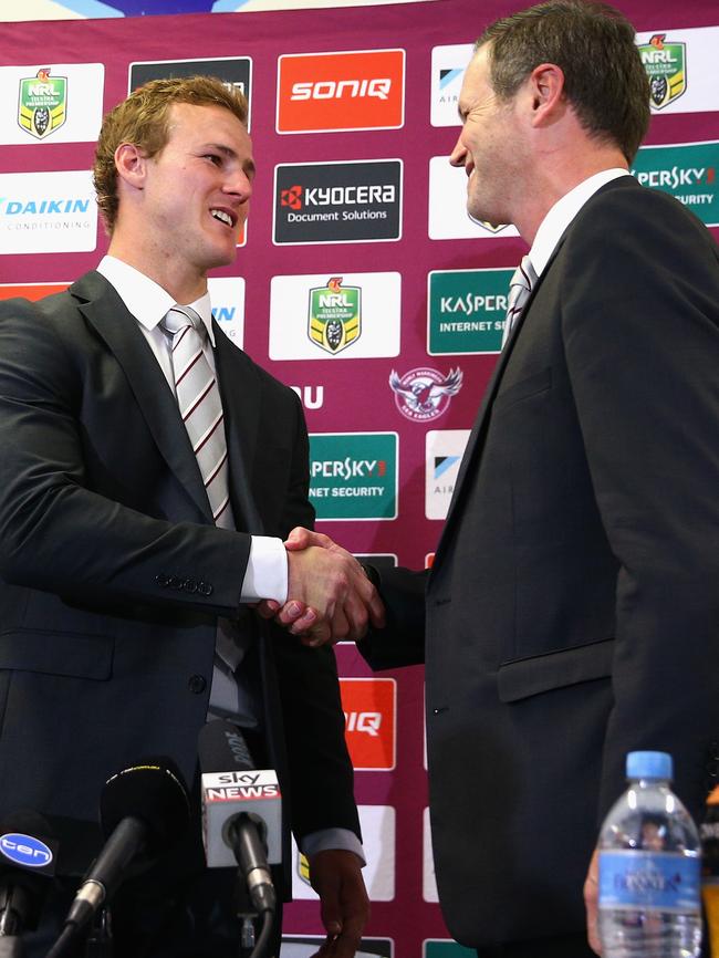 Cherry-Evans  shakes hands with Manly chairman Scott Penn.