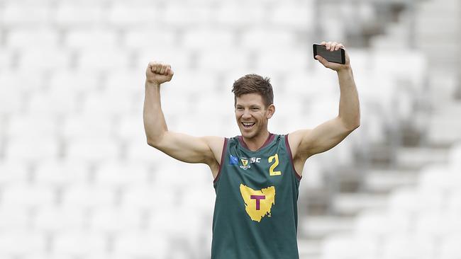 Tim Paine donning a Tasmania AFL jumper in England.