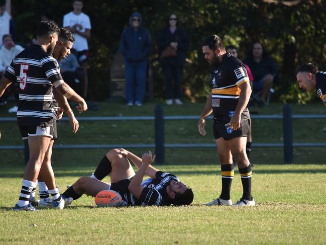 Evan Manning clutches at an injured leg. Picture: Sean Teuma/NewsLocal