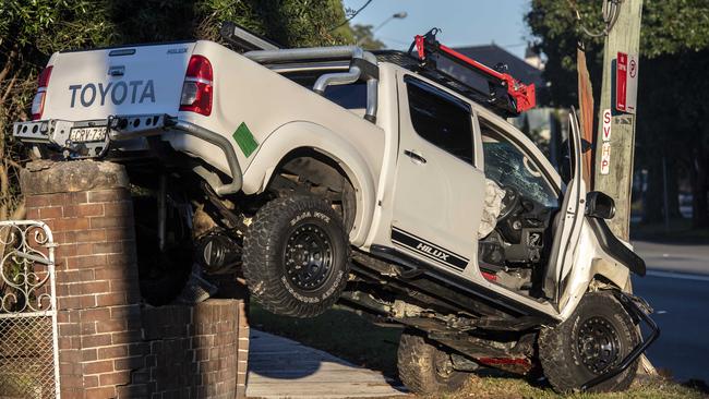 The car’s tow ball has become stuck on a brick wall. Picture: Gordon McComiskie