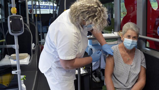 A woman receives a Covid jab on a ‘vaccination centre bus’ operating in the small towns of South Tyrol, Italy. Picture: Getty Images.