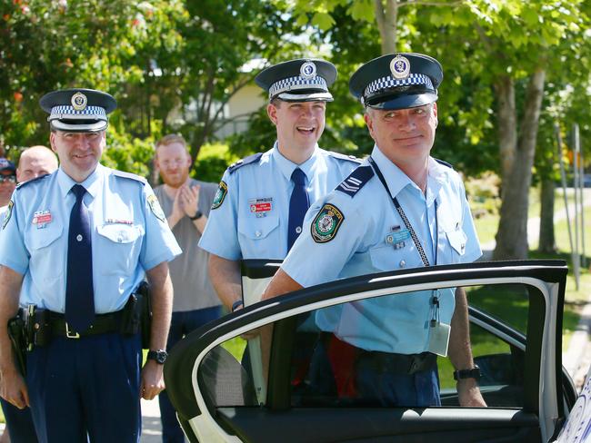 Ever the gentleman, Sen Con Pearce holds the rear door for his wife and daughter to join him as he’s escorted home on his last day. (AAP Image/Sue Graham)