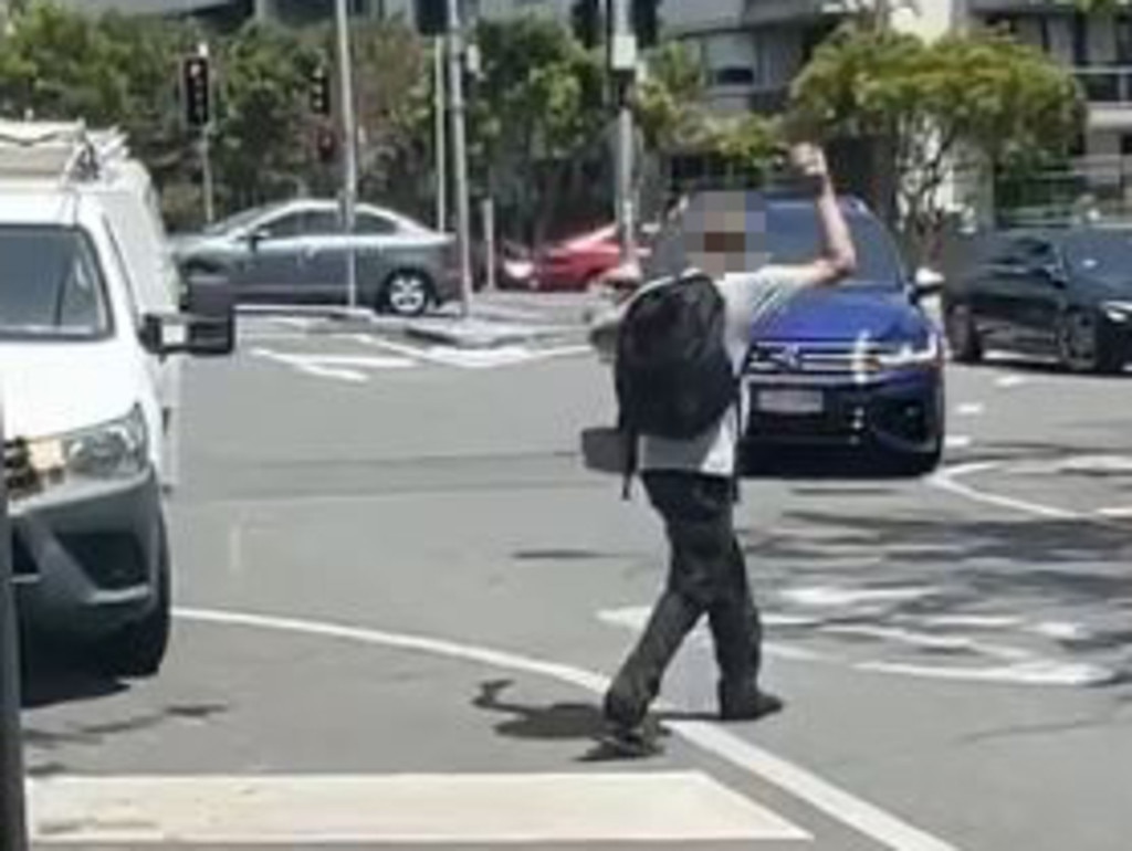 A man gesticulating at traffic on James St.