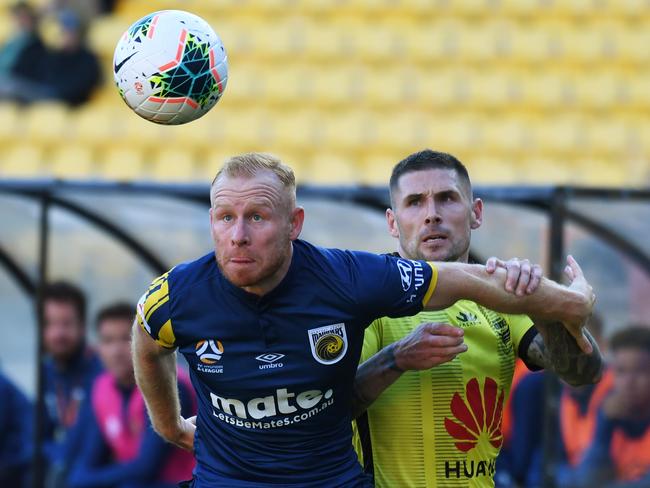 Ziggy Gordon of the Mariners (left) holds back Gary Hooper of the Phoenix during the Round 13 A-League match between the Wellington Phoenix and the Central Coast Mariners at SKY Stadium in Wellington, New Zealand, Saturday, January 4, 2020. (AAP Image/SNPA, Ross Setford) NO ARCHIVING, EDITORIAL USE ONLY