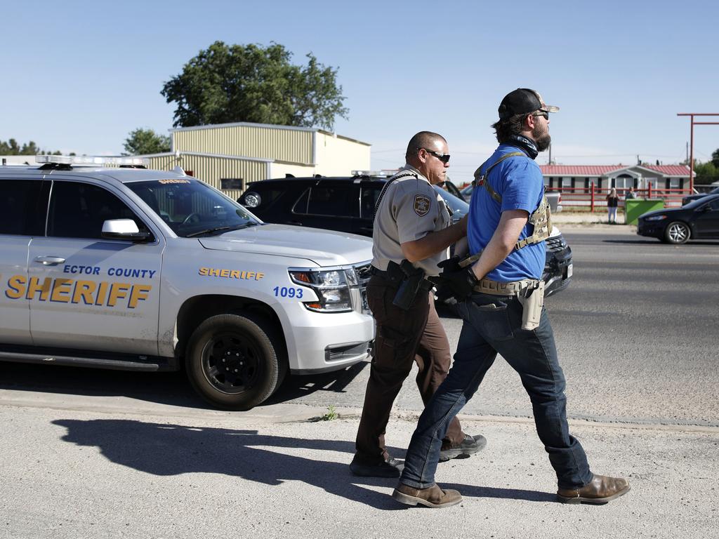 Protester Wyatt Winn is led away in handcuffs. Picture: Eli Hartman/Odessa American via AP