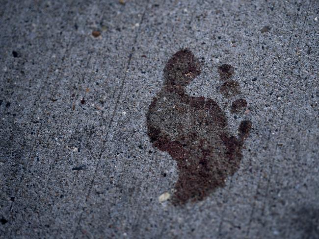 A bloody footprint on a sidewalk near the site of the shooting. Picture: AP