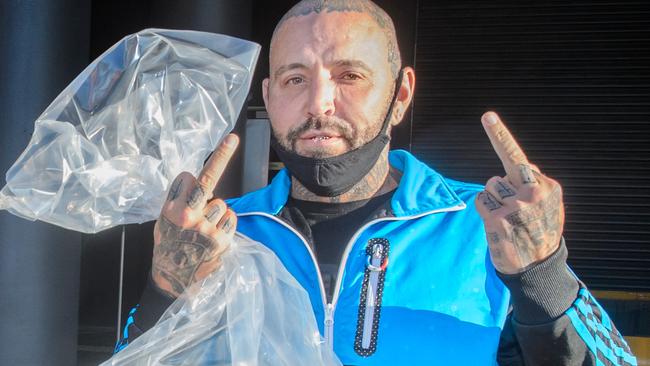 Toby Mitchell flips the bird on his release from the Spencer St Police Complex. Picture: Jay Town