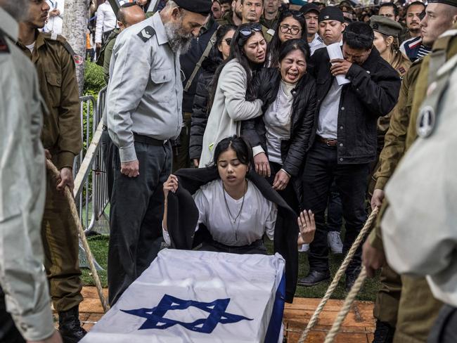 Family members of Israeli-Filipino soldier Cidryk Garin, one of 21 soldiers killed in a single incident while in combat in the Gaza Strip, gather for his funeral in Tel Aviv. Picture: Marco Longari/AFP