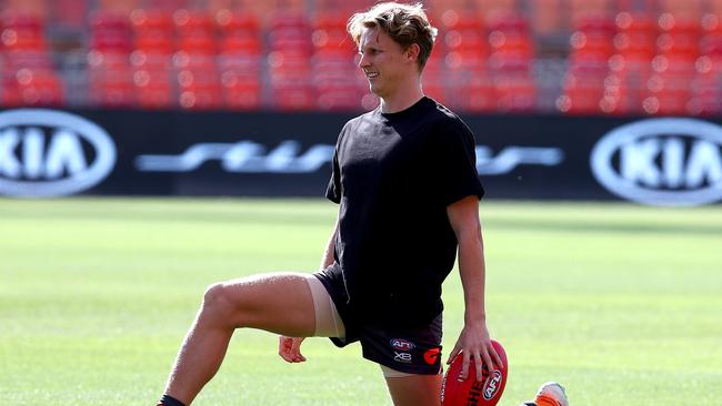 Giants' Lachie Whitfield warms up in a black t-shirt to support the Black Lives Matter movement before the round 2 match between GWS Giants and North Melbourne Kangaroos at Giants Stadium in Homebush. Picture: Toby Zerna