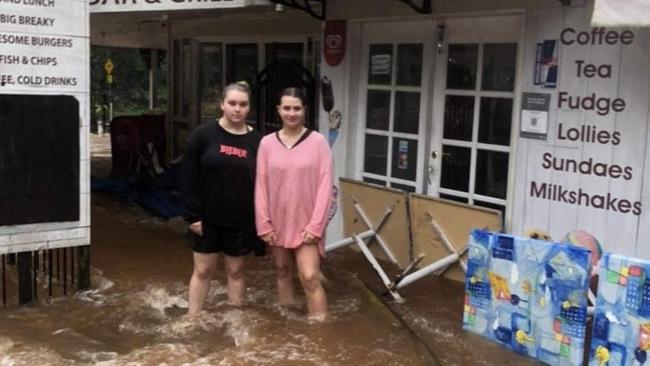 Curtis Falls Cafe manager Hannah Battistuzzi and staff member Libby Thornton are pleading with motorists to be mindful of driving in flooded waters past their business saying it creates more work for the businesses clean up.